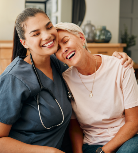 caregiver and elderly woman smiling