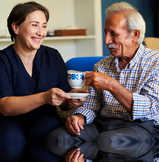 nurse serving tea to older