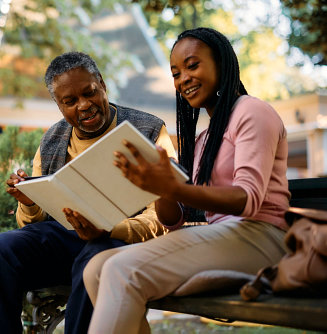 nurse and elder holding book