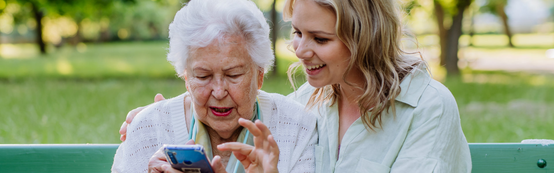 elder holding phone with daughter