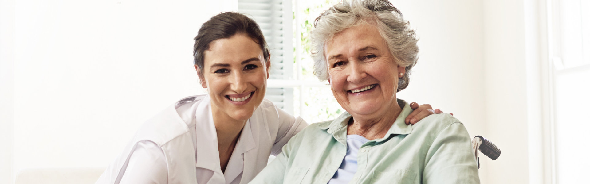 senior and nurse smiling