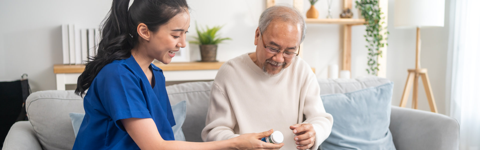 nurse giving medicine to elder